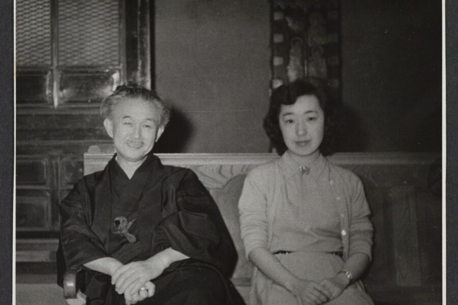 Black and white photograph of Soetsu Yanagi, left, and Yoshiko Uchida, right, seated on a sofa.